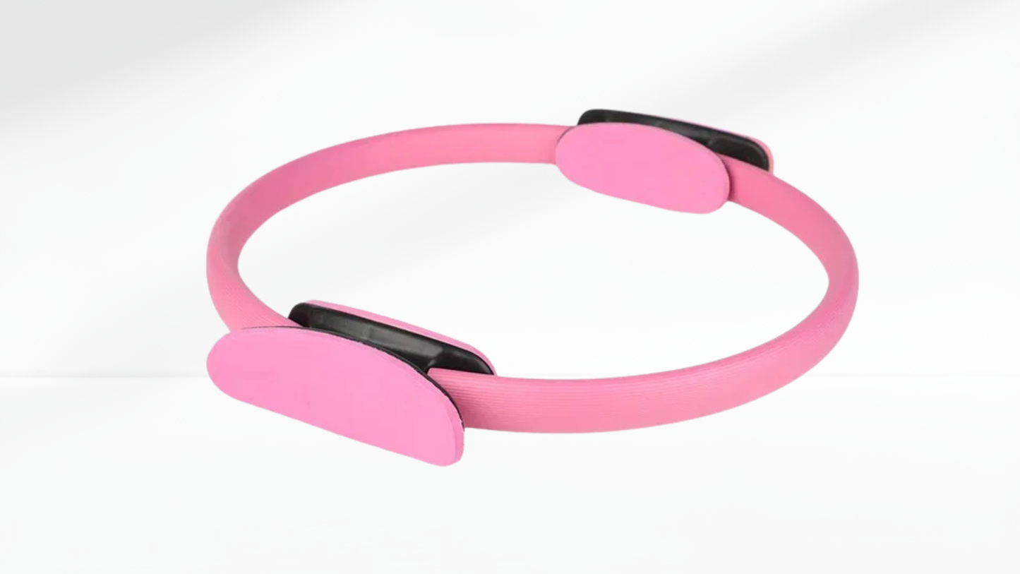 Pink Pilates ring with black accents on a white background
