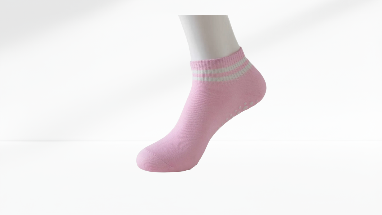 Pink ankle grip sock with white stripes on a white background