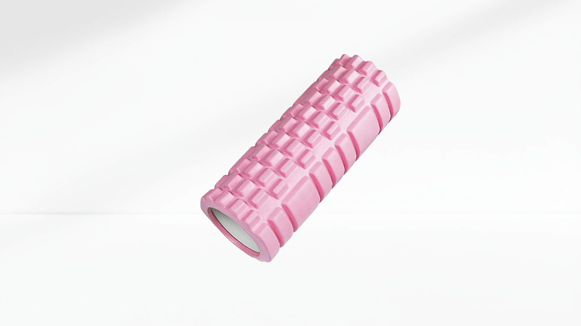 Pink foam roller on a white background