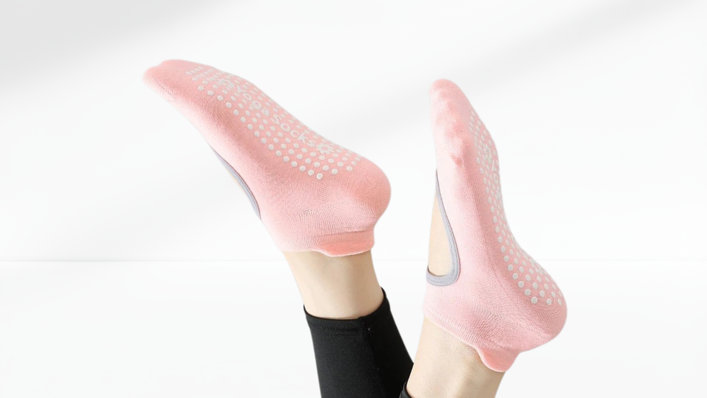 Pink grip socks with textured sole on a white background