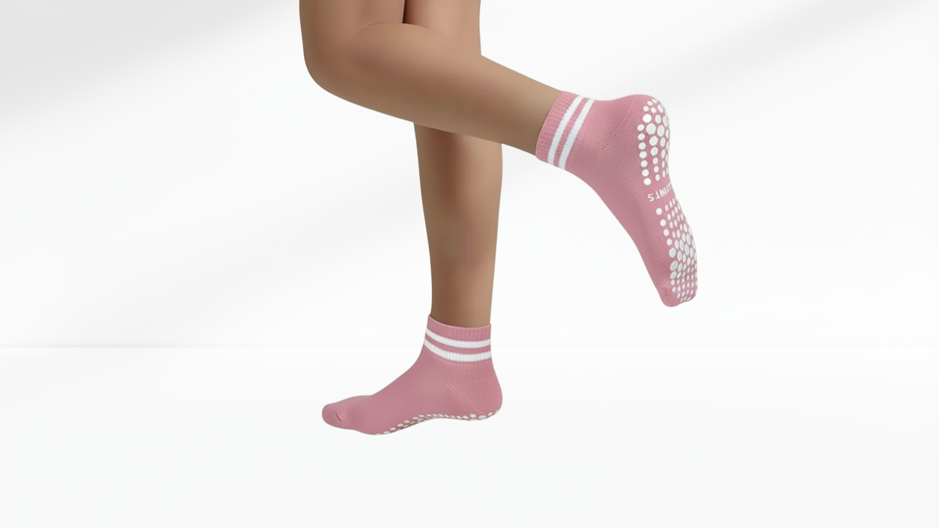 Pink grip socks with white stripes worn by a person on a white background