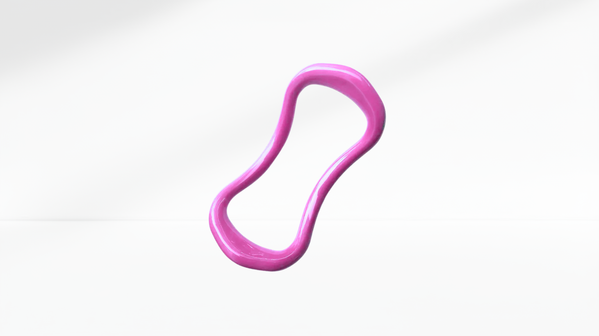 Pink pilates ring on a white-grey background