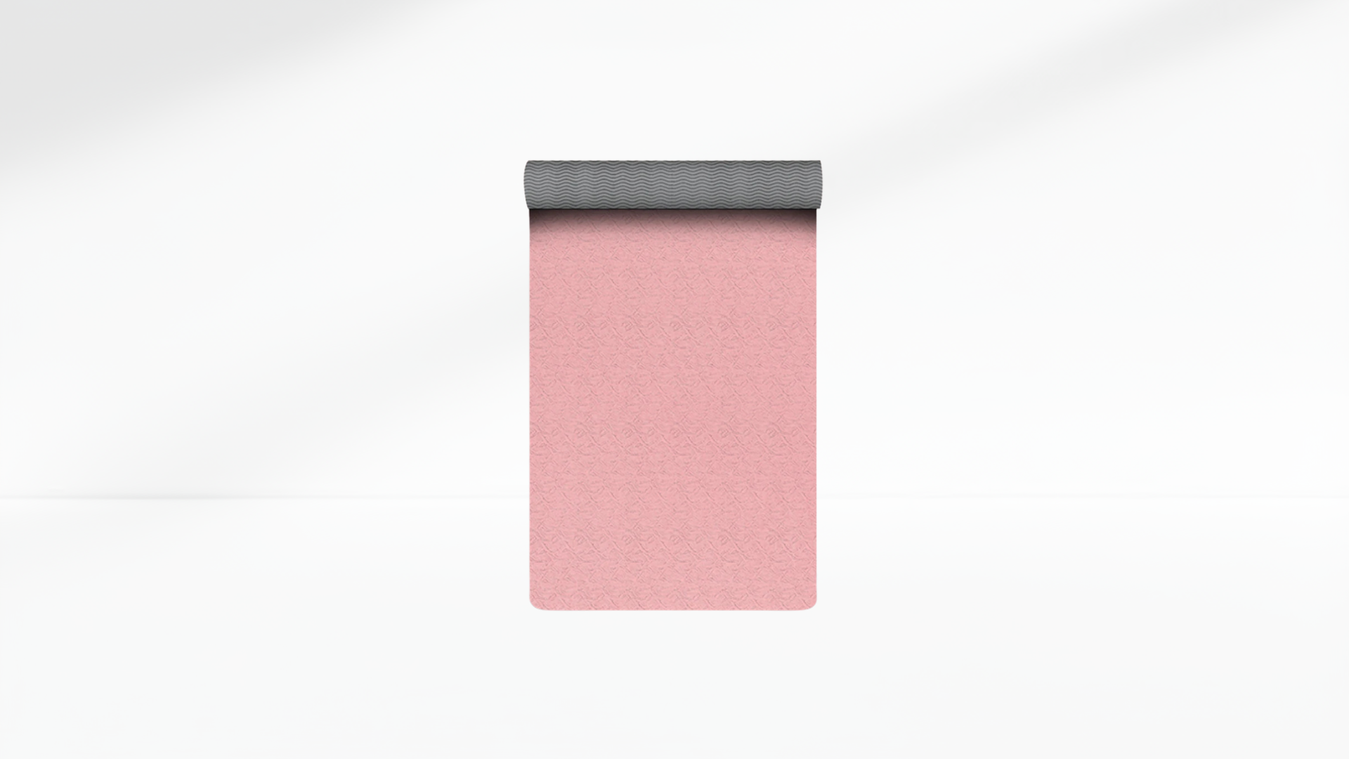 Pink yoga mat with gray base on a white background