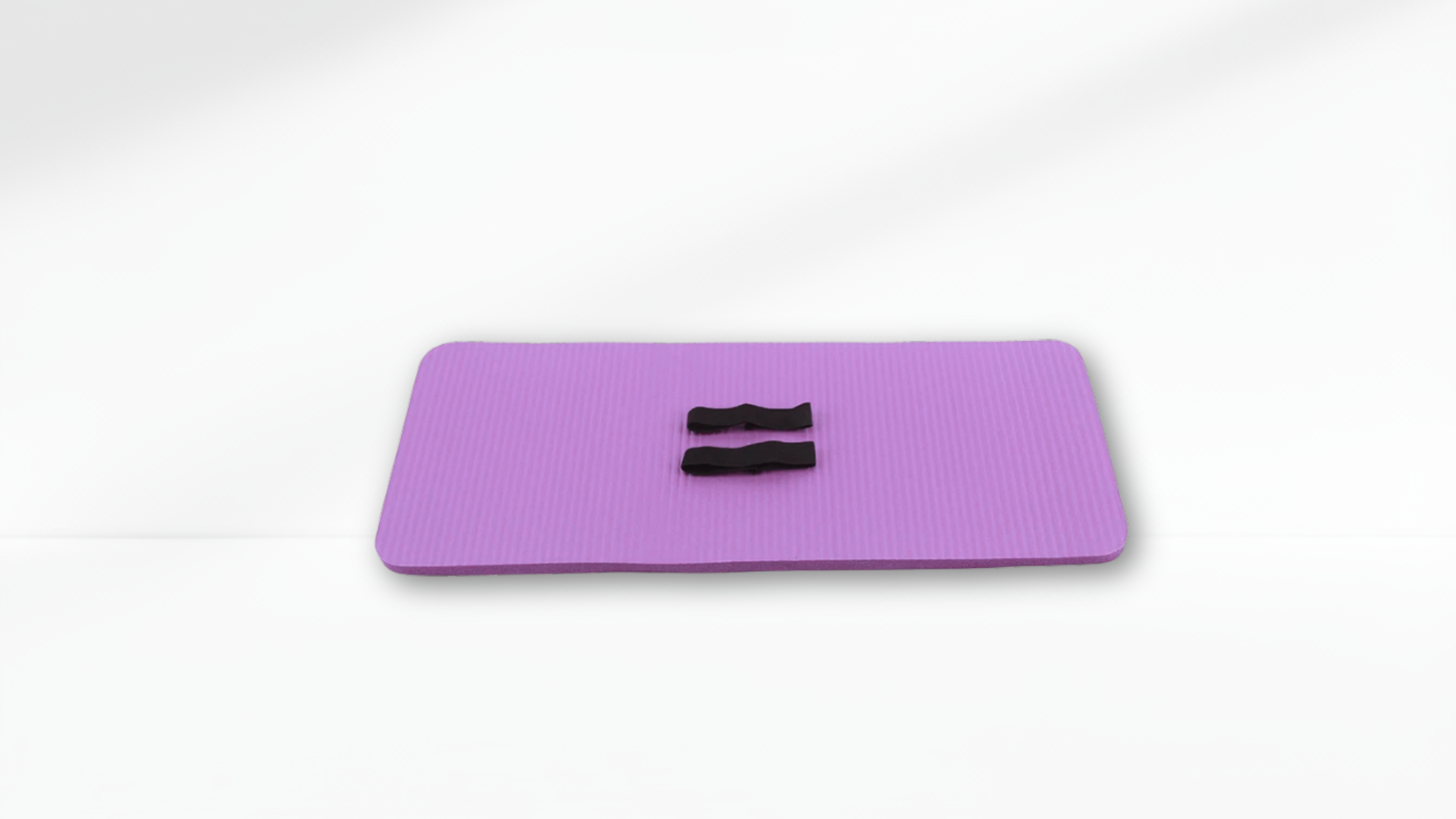 Purple exercise mat with black handles on a white background