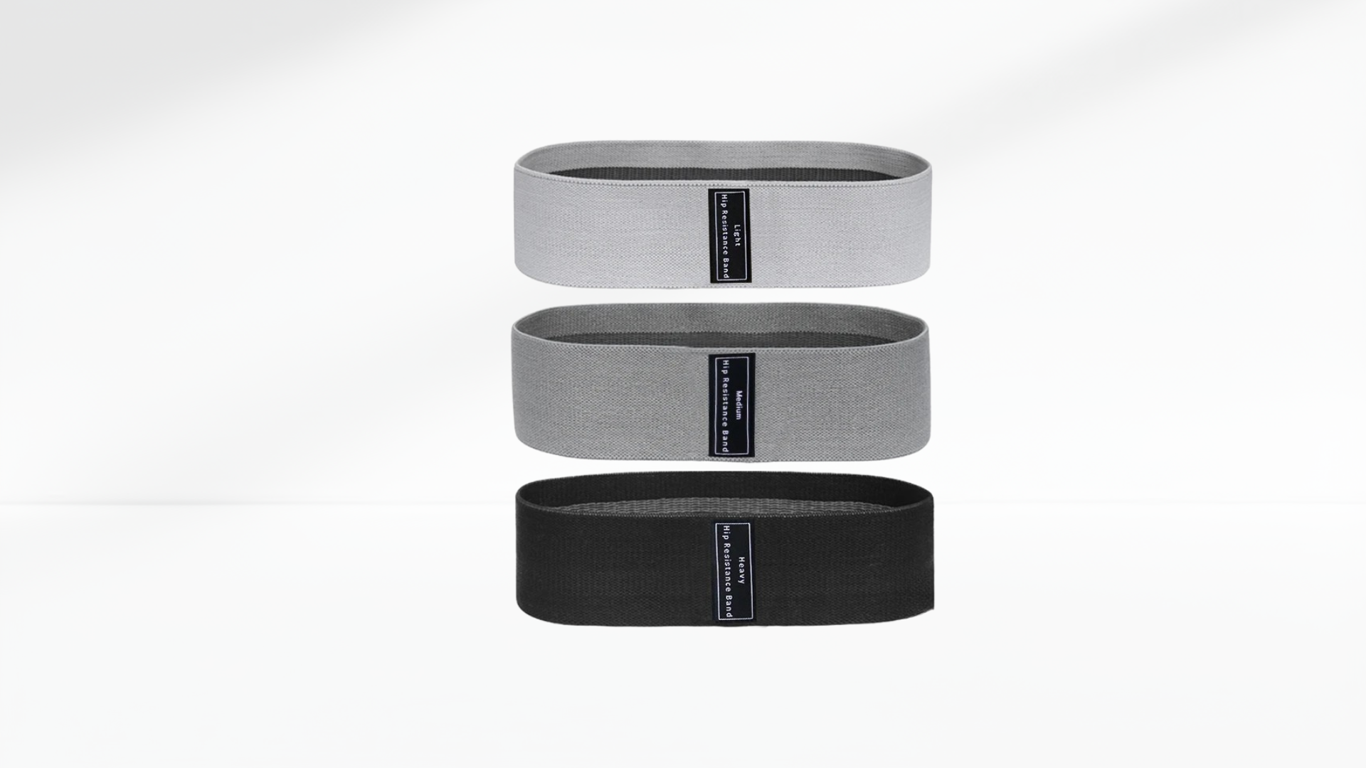Three resistance bands in gray and black on a white background