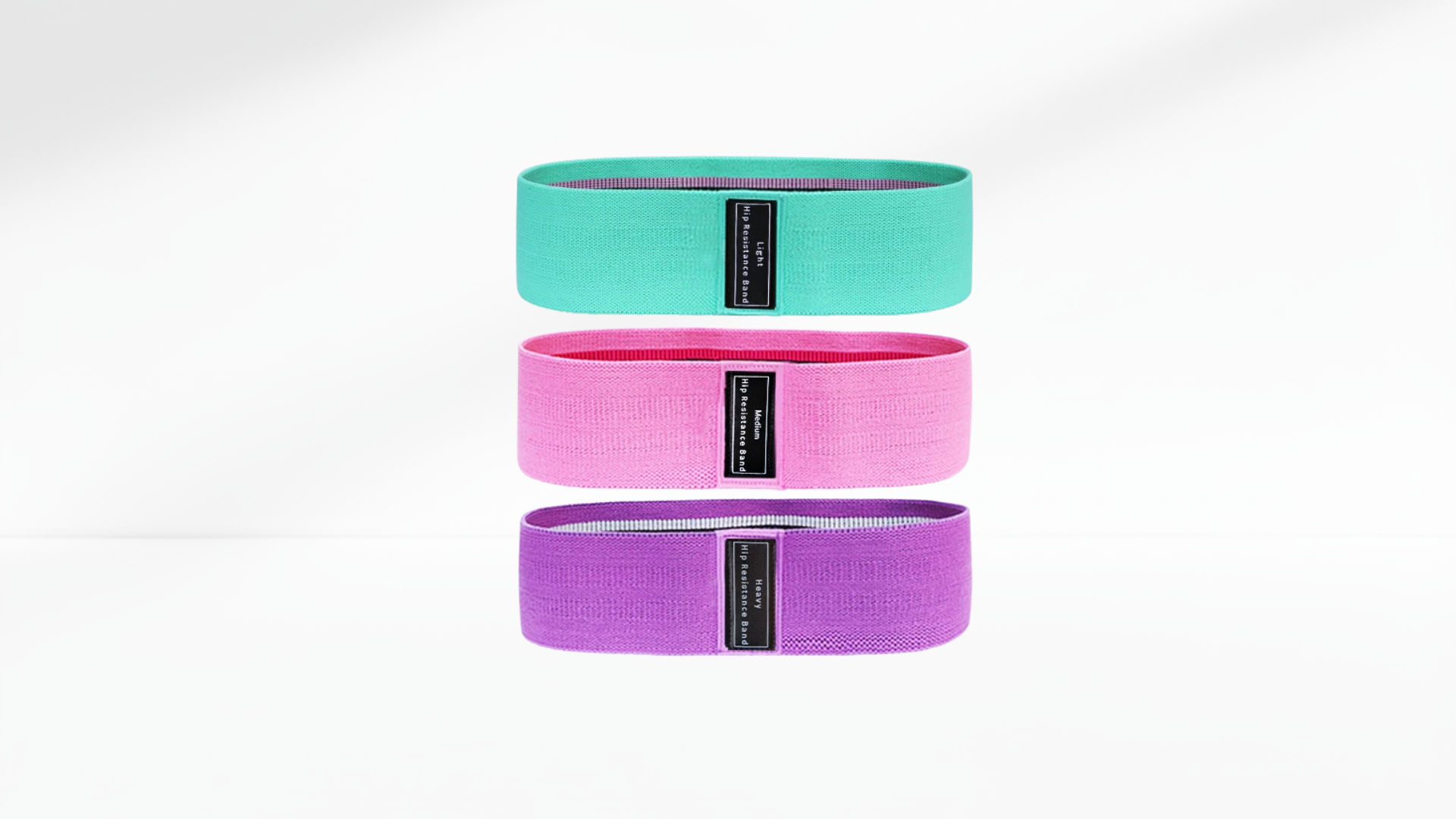 Three resistance bands in teal, pink, and purple on a white background