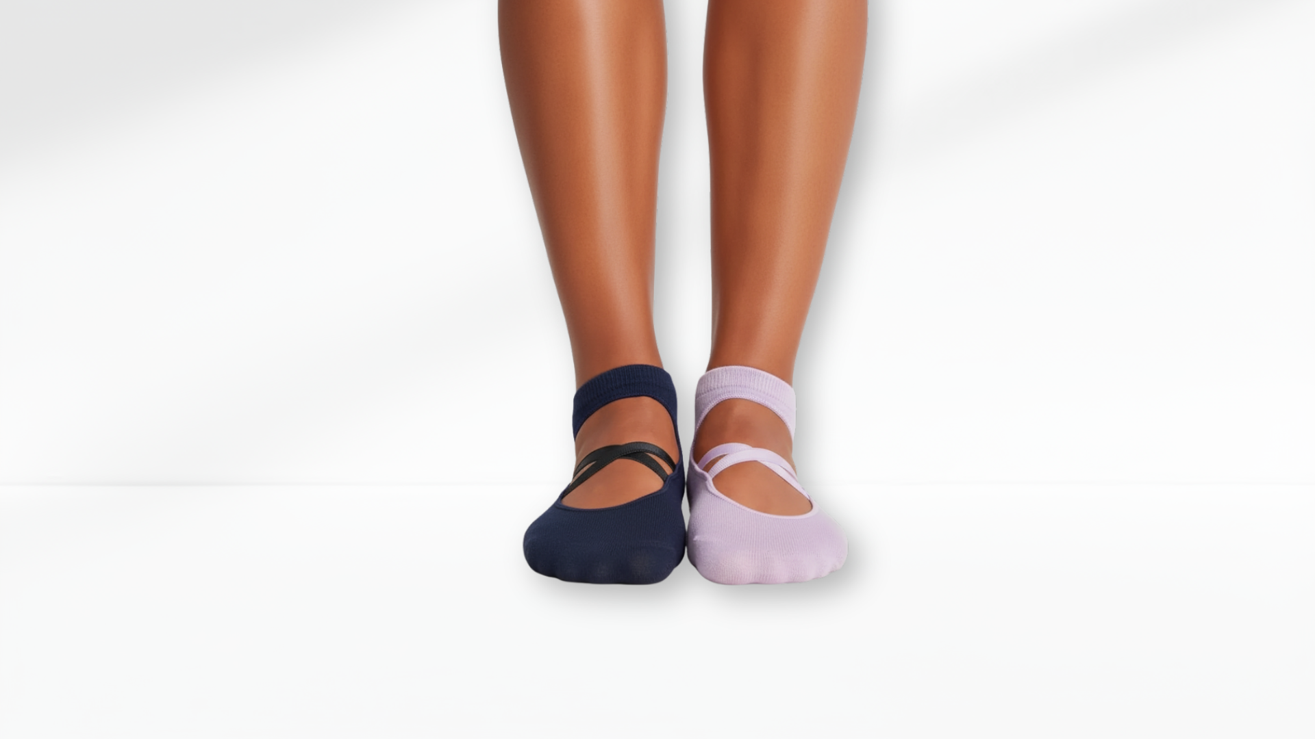 Two pairs of Grip Socks – Ballet Mary Jane, one navy and one pink, on a white background.