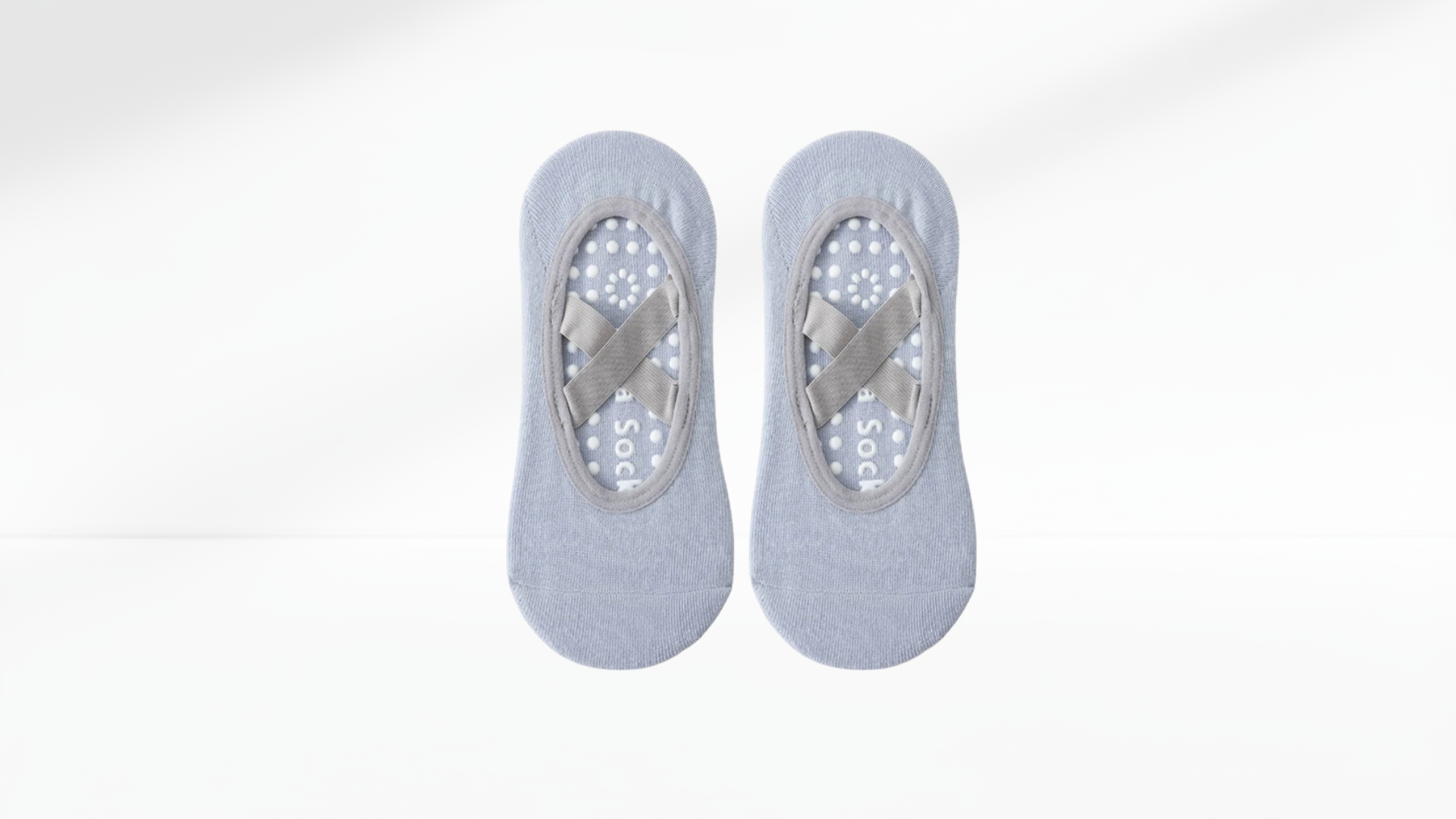 Two pairs of gray no-show grip socks ballet on a white background