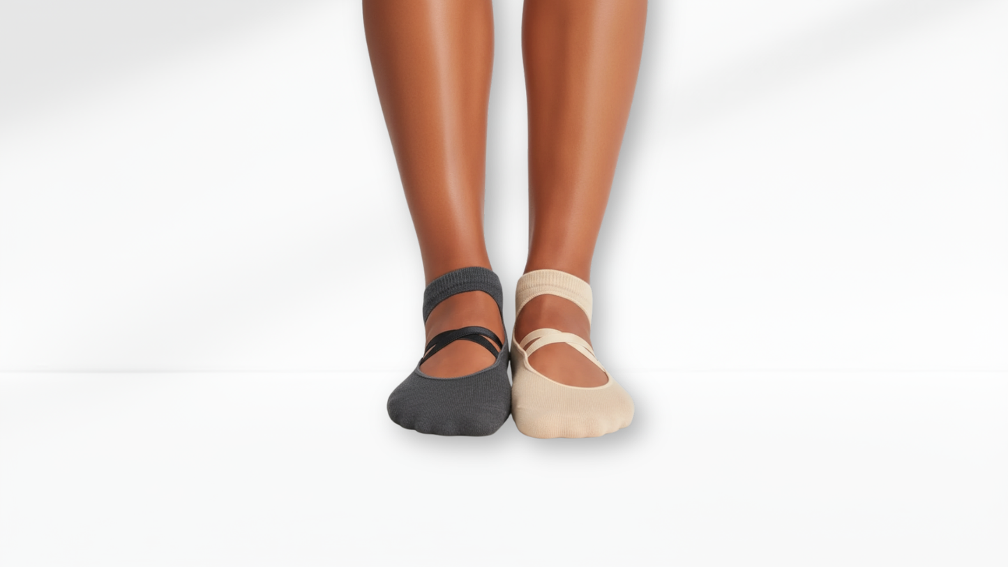 Two pairs of grip socks, one black and one beige, on a white background.