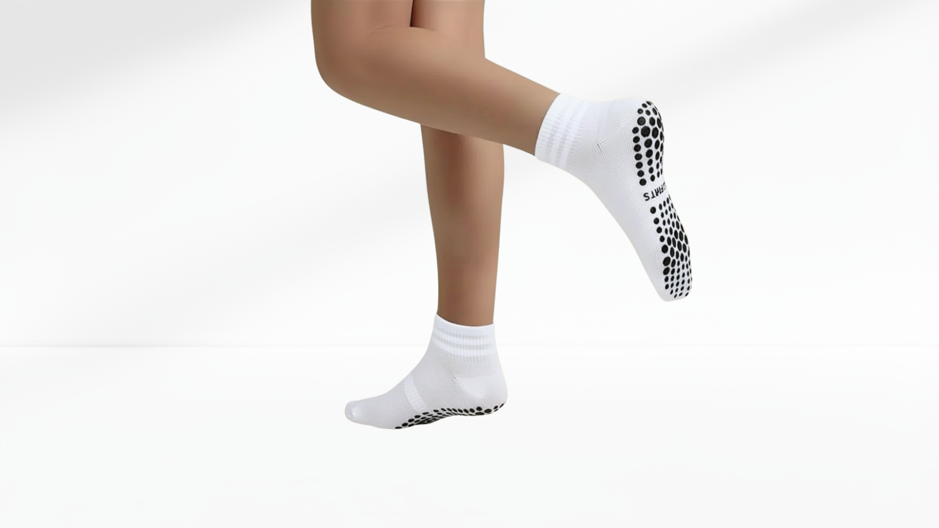 White grip socks with black sole pattern on a white background