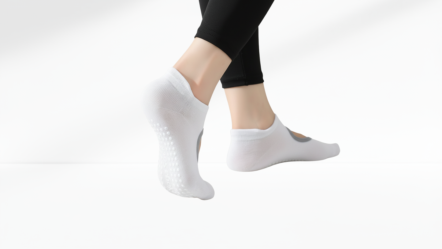 White grip socks with textured sole worn by a person on a white background