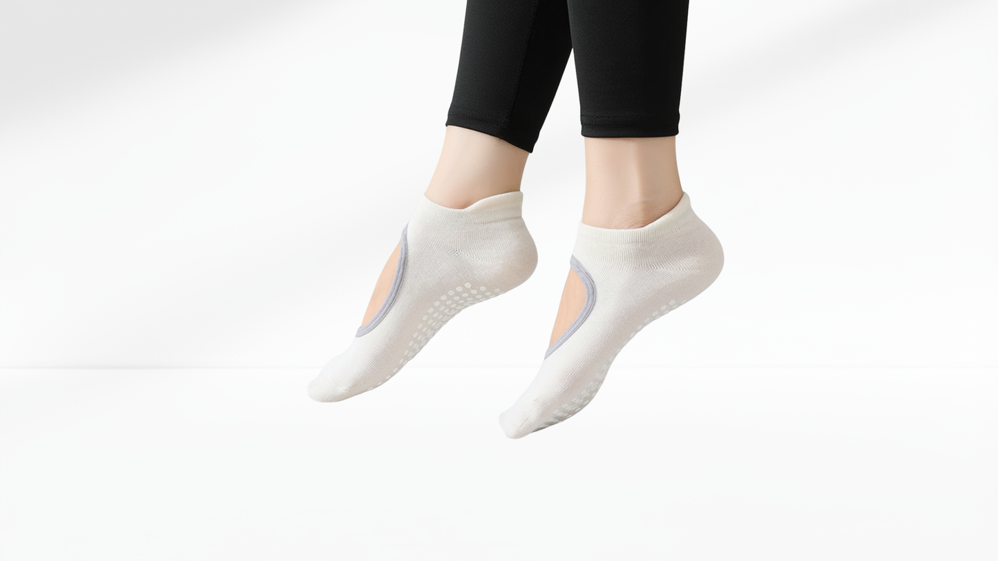 White grip socks worn with black leggings on a white background