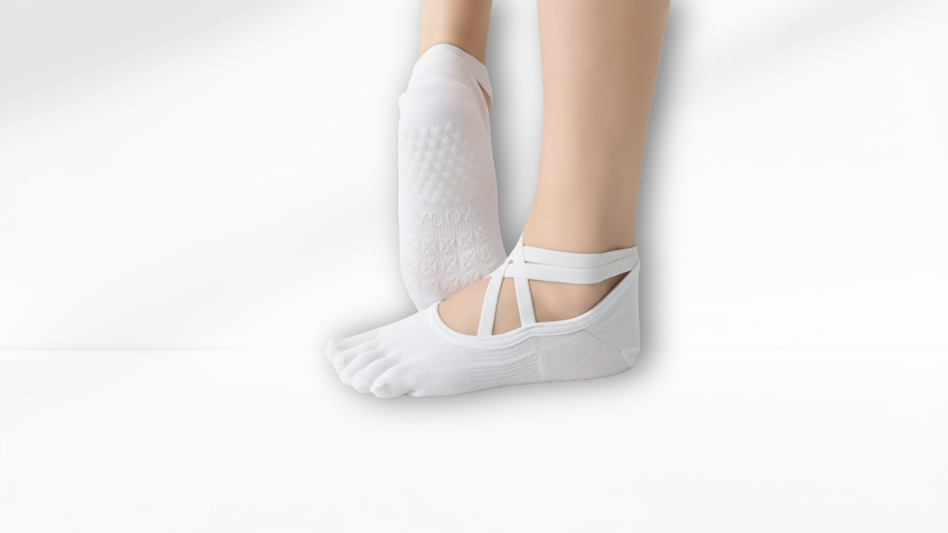 White toe sock ballet with a strap worn by a person on a white background