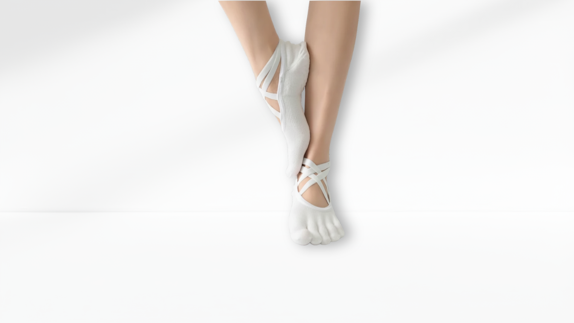 White toe sock sandals worn by a person on a white background