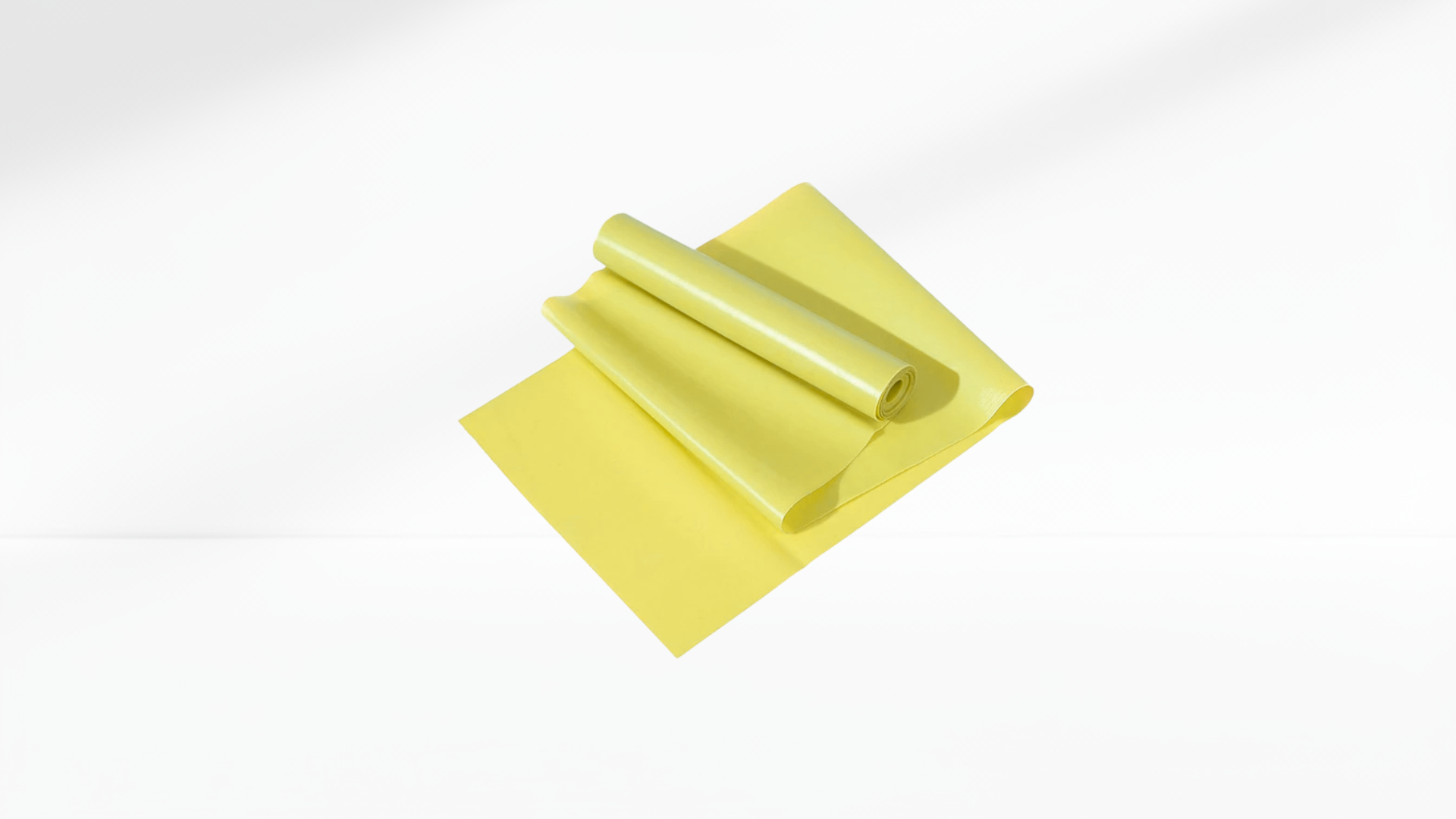 Yellow Yoga & Pilates Elastic Resistance Band roll on a white background