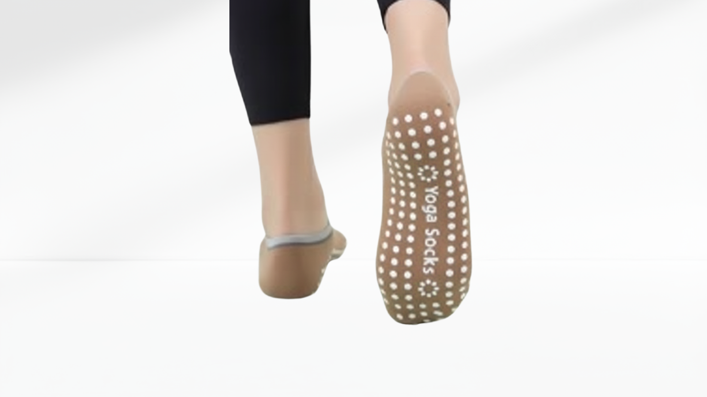 Yoga grip socks ballet with footprints worn by a person on a white background