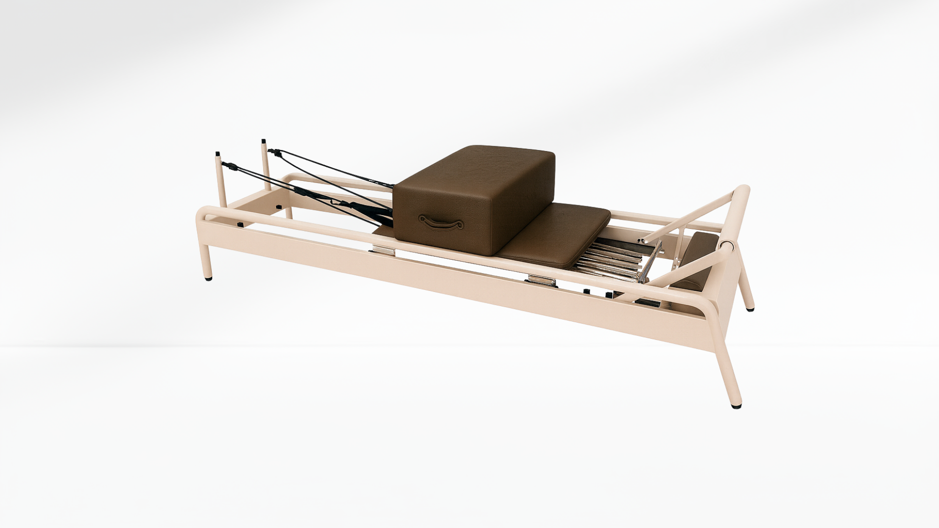 brown Pilates reformer on a white background