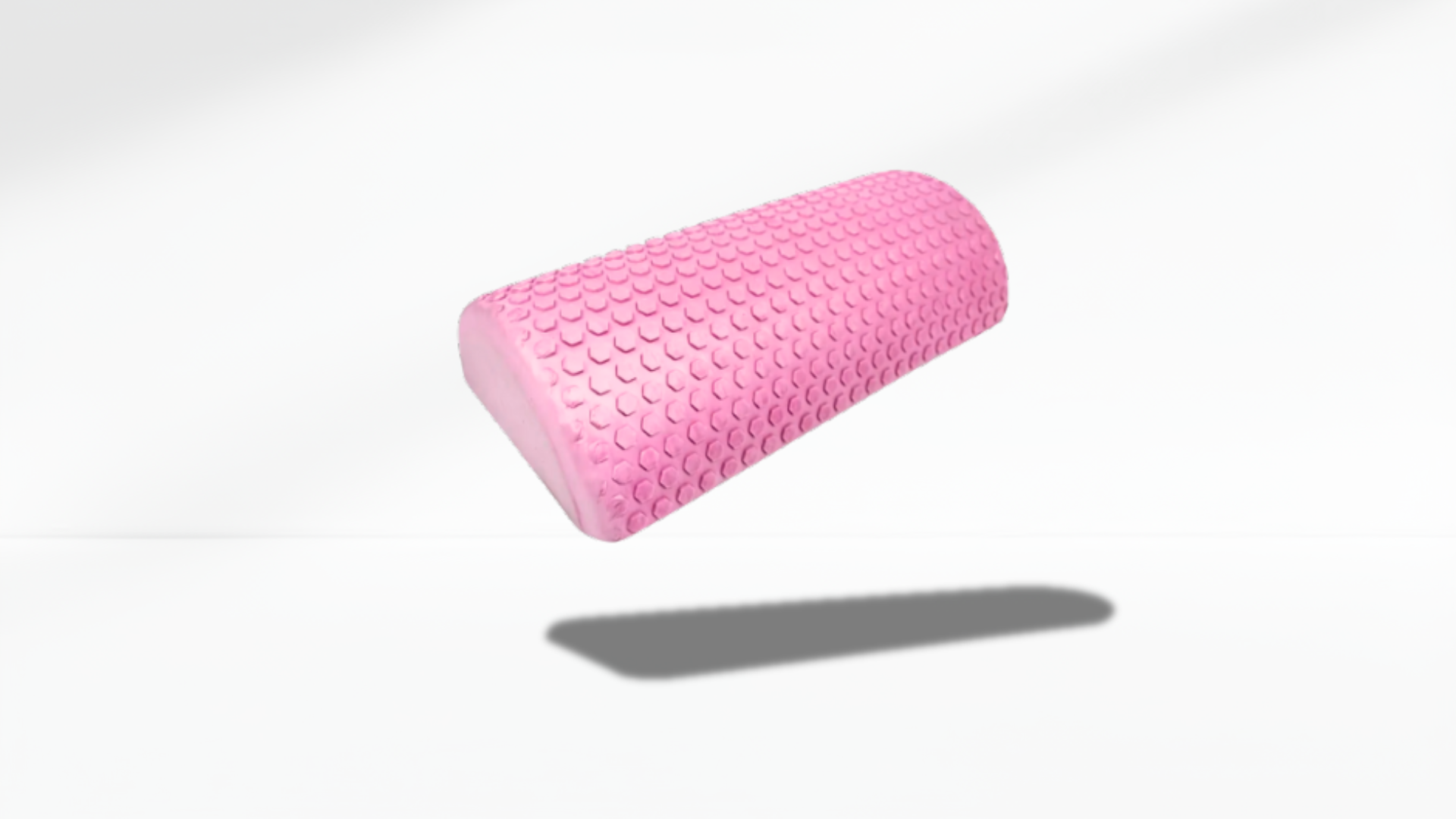 pink textured half foam roller shown in an angled floating view with soft shadow, highlighting its curved shape and massage surface.