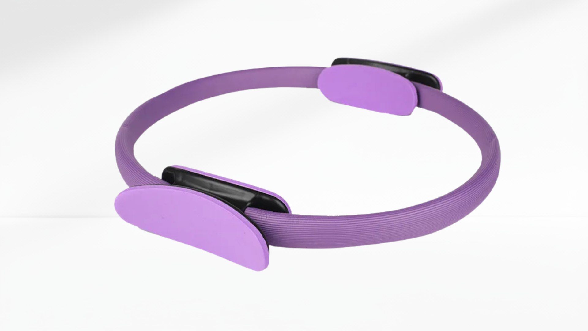 purple Pilates ring with black accents on a white background