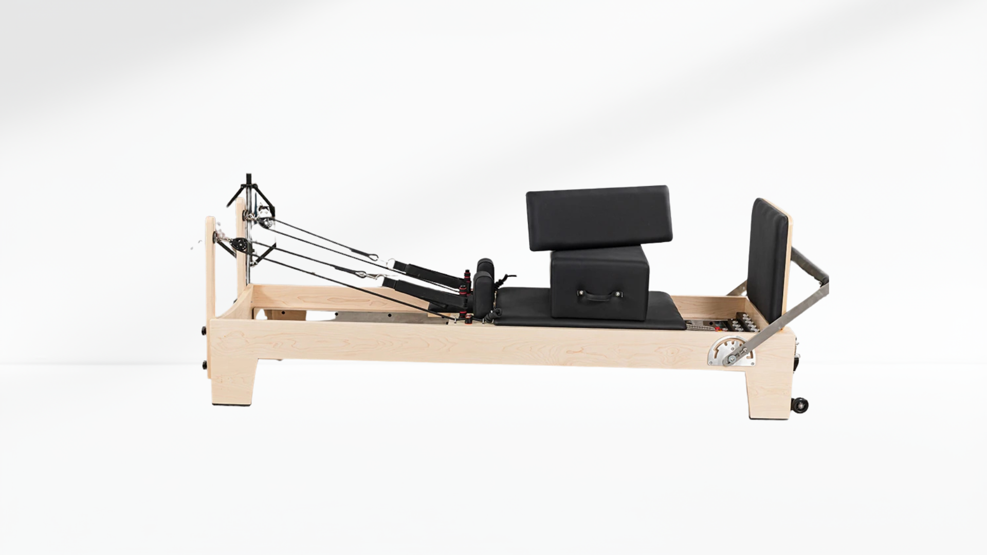 white maple Pilates reformer machine on a white background
