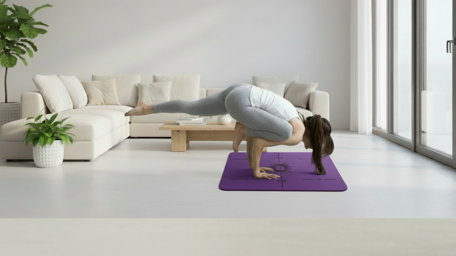 Woman practicing an advanced yoga balance pose on a purple flat support mat in a bright modern room.